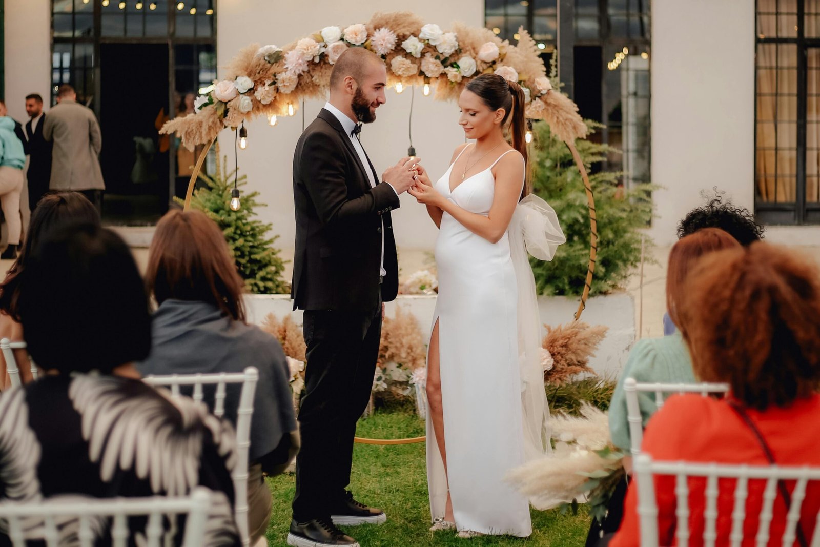Bride and groom exchange vows in a picturesque outdoor setting. Perfect moment captured.
